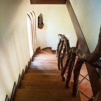 Stairwell with sculpted natural wood railing